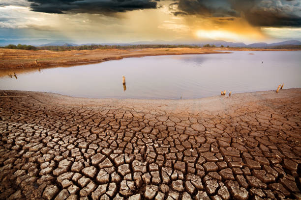 istock thunder storm sky Rain clouds Cracked dry land without wate 1165643060