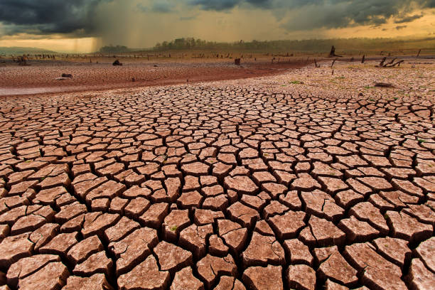 istock thunder storm sky Rain clouds Cracked dry land without wate 1165644993
