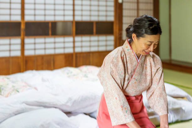 istock Japanese Woman Bowing in a Ryokan 1165648548