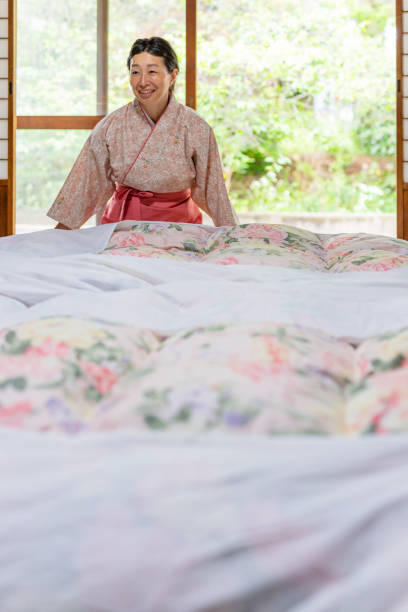 Middle-aged women arriving at their accommodation and lying down on the bed