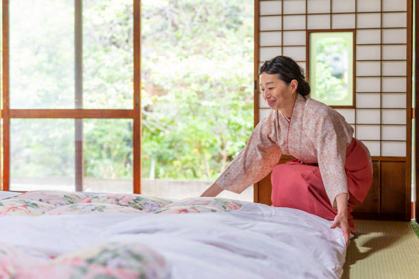 istock Japanese Woman Making a Traditional Futon Bed 1165648558