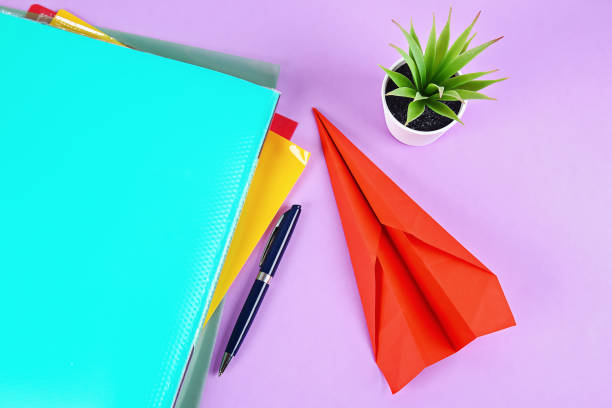 istock Procrastination Creating a paper airplane instead work. Delaying affairs, laziness. 1165648855