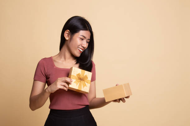 istock Young Asian woman open a gift box. 1165659110