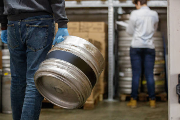 istock Aluminum barrel carried by worker in warehouse 1165660814