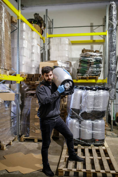 istock Brewer putting keg on shoulder in warehouse 1165660954