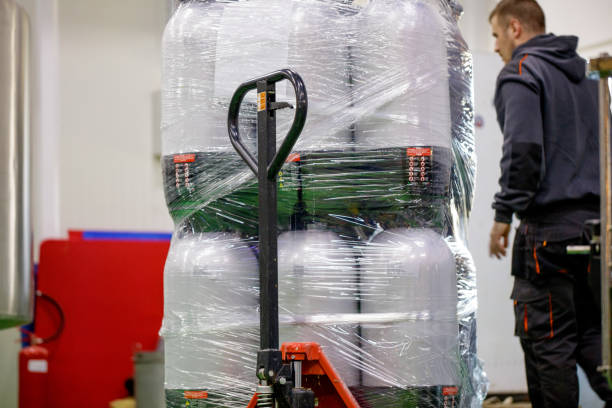 istock Kegs stacked and wrapped in a foil on manual forklift 1165660984