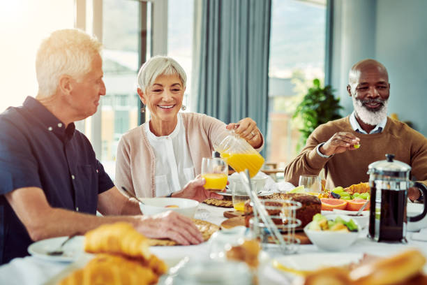 letting him try my homemade orange juice - retirement senior adult breakfast active seniors imagens e fotografias de stock