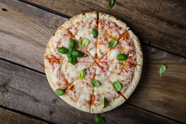 istock Pizza Margherita. Cheese pizza with fresh basil 1165664103