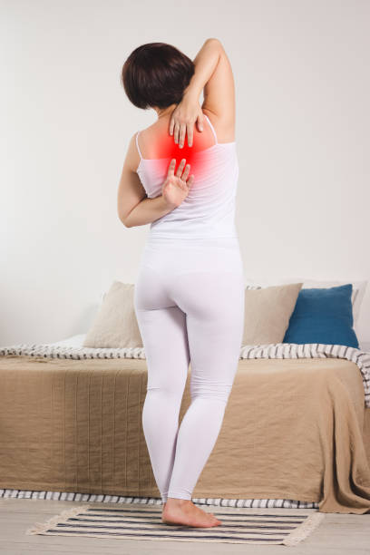 istock Back pain, woman suffering from backache at home 1165665474
