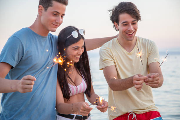 istock Young Catalan Friends Holding Sparklers in Celebration 1165666778