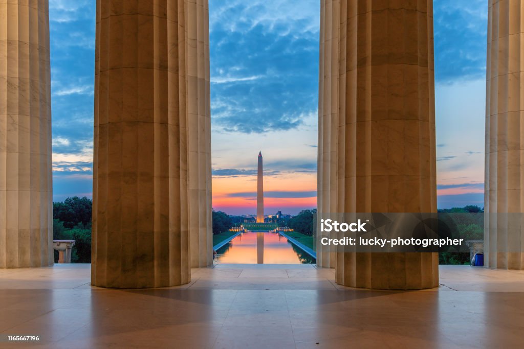Lincoln Memorial at sunrise in Washington, D.C. Sunrise view at Washington Monument and Reflecting Pool from Lincoln Memorial in Washington, D.C., USA. Washington DC Stock Photo