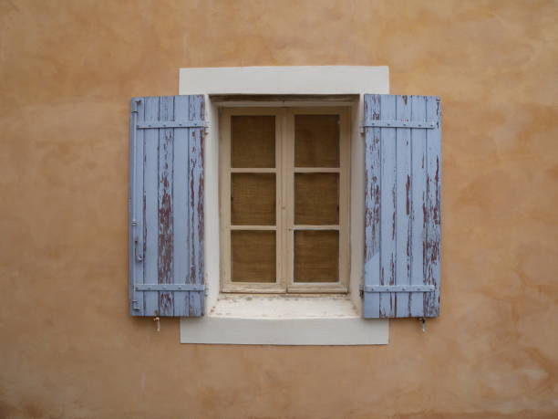 istock Roussillon hill village rustic window blue ocher Provence France 1165669043