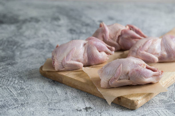 istock Raw uncooked quail. raw meat quails ready for cooking on a cutting board with copy space 1165673338