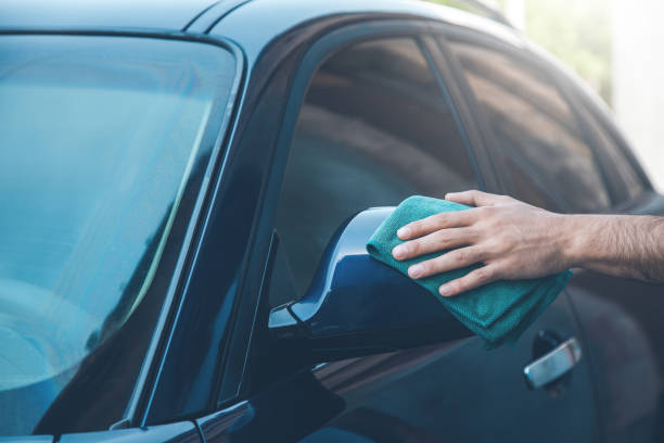 istock young man cleaning car in street 1165674062