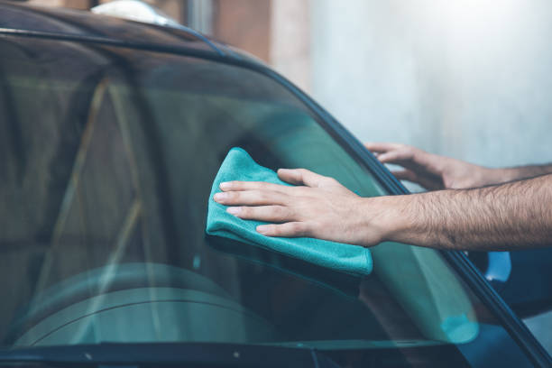 istock young man cleaning car in street 1165674072