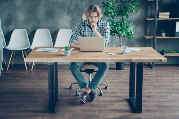 istock Full size photo of focused man using modern technology wearing eyeglasses eyewear checkered plaid shirt sit desk in industrial 1165674159