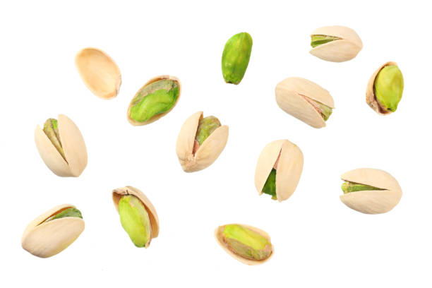 istock pistachio isolated on the white background. top view 1165674392