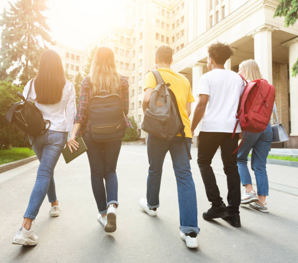 istock College students walking together outdoors after studies 1165675323