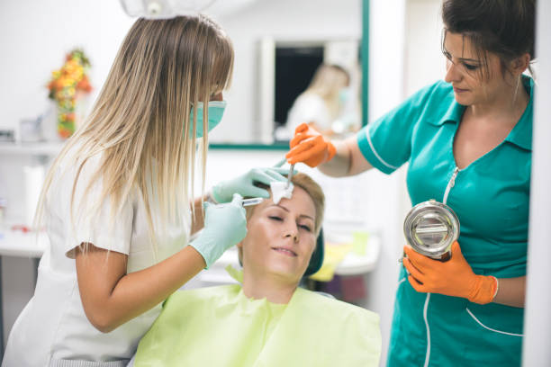 istock Young woman is getting a collage injection in her face. 1165676455