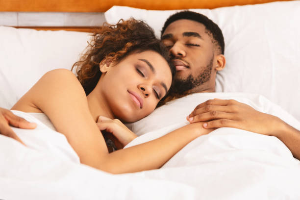 istock Loving couple sleeping in bed and hugging 1165677345