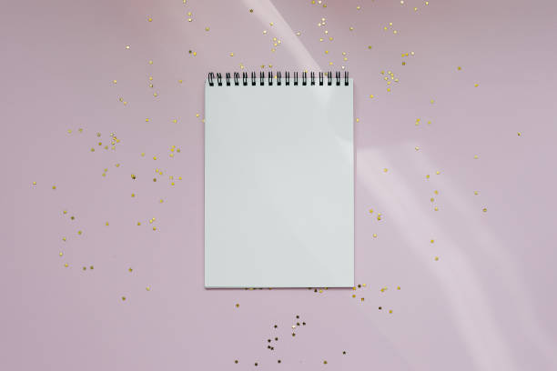 istock Empty notebook blank with golden sparkles confetti. Holiday mockup. Christmas concept. Flat lay, top view, copy space 1165677556
