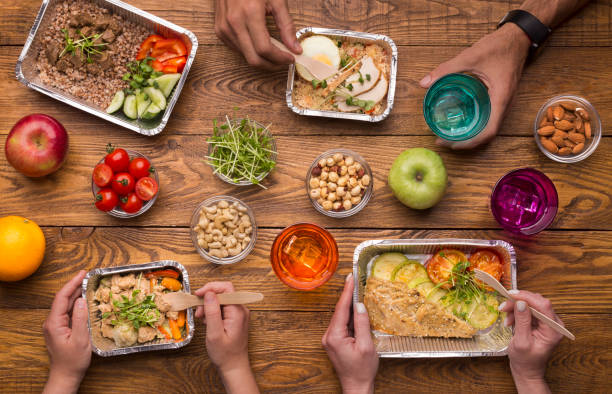 istock Foil boxes, fruits, nuts and vegetables on wooden table 1165679168