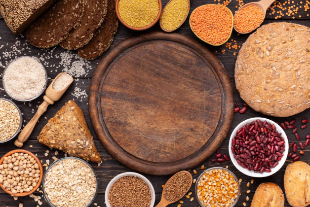 istock Cutting board with copy space surrounded by gluten free grains 1165679333