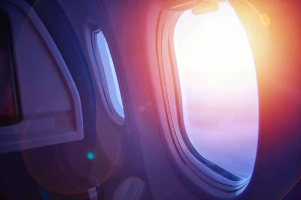 travel concept. sunset through an airplane window. plane interior. - wing airplane window sunset imagens e fotografias de stock