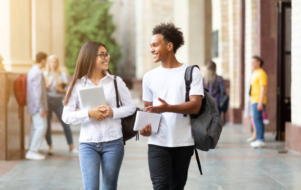 istock Young student couple going to college class 1165680927
