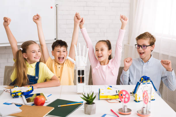 istock Children celebrating success after doing robots at lesson 1165681060