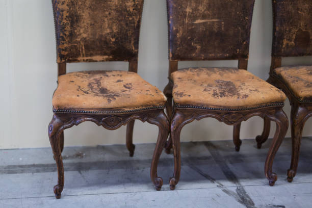 istock Worn Brown Vintage Leather and Wooden Chairs 1165681212