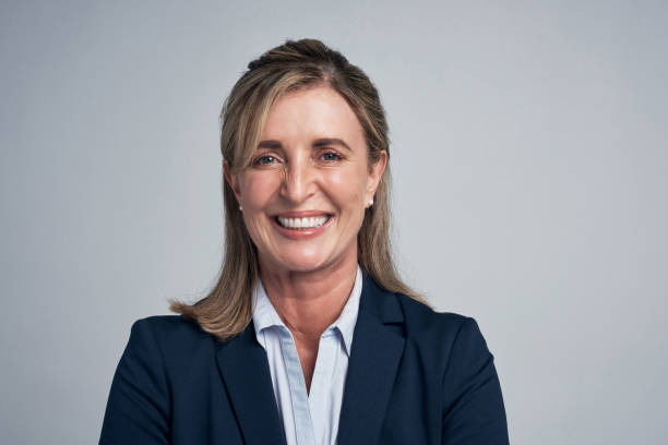 Confidence is a asset that can be honed and strengthened every day Studio portrait of a mature businesswoman standing against a grey background headshot stock pictures, royalty-free photos & images