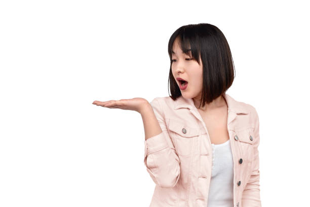 istock Shocked ethnic woman looking at empty space over hand 1165682538