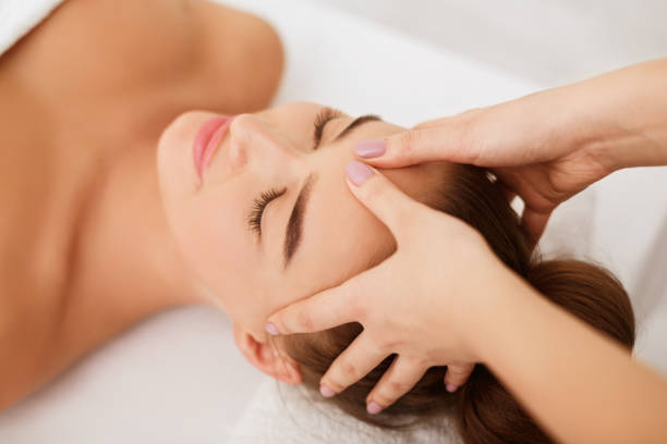 istock Woman enjoying head massage at spa center 1165682875
