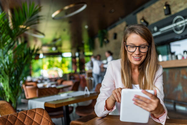 istock Young female entrepreneur reading electronic book on digital tablet 1165682897