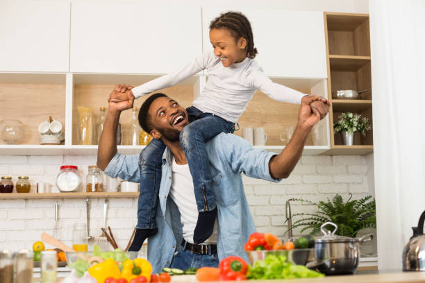 istock Happy daddy carrying his little daughter on shoulders 1165682962