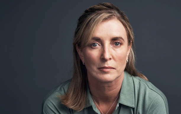 Going through the phases of life Studio portrait of a mature woman posing against a grey background grave stock pictures, royalty-free photos & images