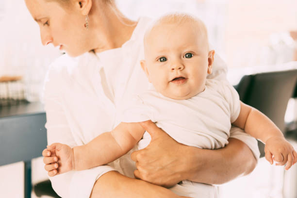 istock close-up baby on mom's hand 1165685012