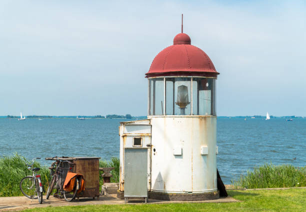 istock Two bicycles and a little white lighthouse 1165685631