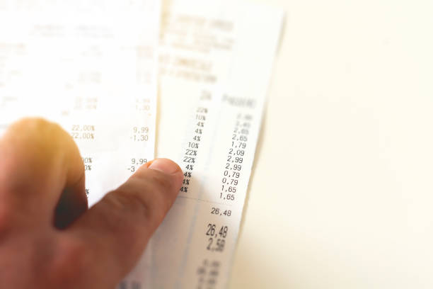 istock checking a receipt by analyzing the numbers, expenses and profits. 1165686935
