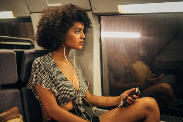 istock Curly haired woman riding in train 1165687176