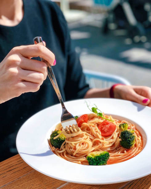 istock Woman eating meatballs horizontal 1165688458