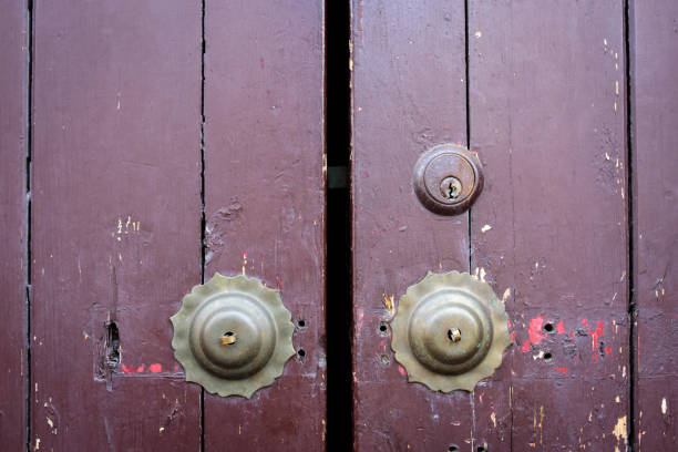 Image of old padlock and latch on a brown wooden door