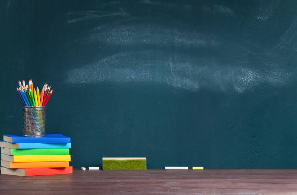 istock Pencil holder on books on school teacher's desk 1165689478