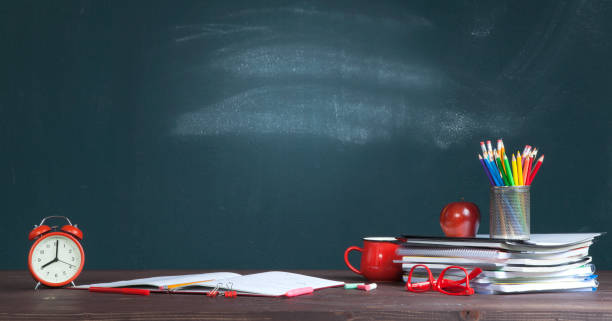 istock Desk of student, alarm clock, notebooks and pencils 1165689485