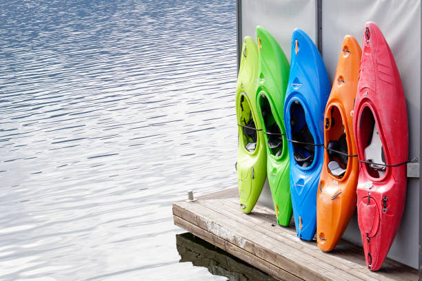 istock Colored Kayaks for rental at lake 1/2 1165690086