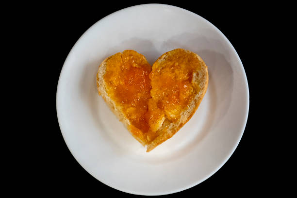 healthy food hearth shaped bread with jam marmalade isolated on black - wheat pasta flour italy imagens e fotografias de stock