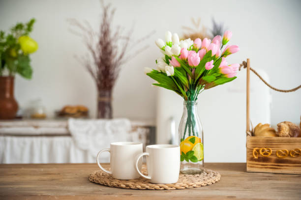 istock Bread in a textured wooden box in the kitchen in a rustic style. Breakfast, bread, white cups in the interior of bright Scandinavian cuisine. 1165691167