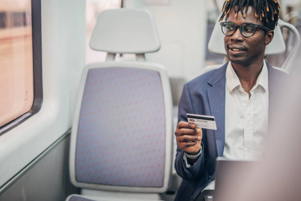 istock Black gentleman with credit card in subway train 1165692184