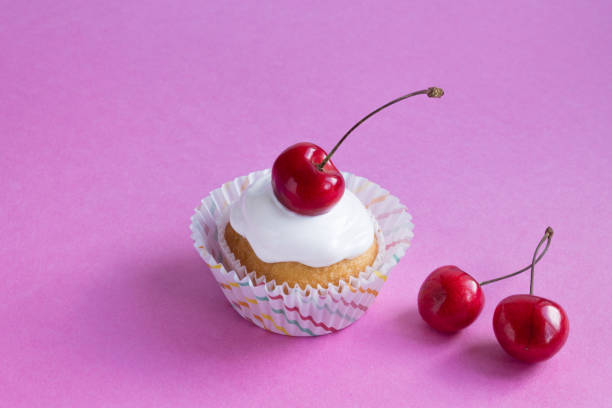 istock Delicious cupcake on a pink purple background. The Central composition. 1165692400